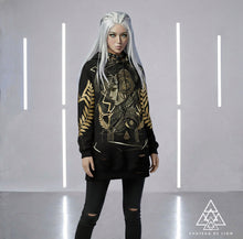 Athena Spoken Hoodie by Chateau De Lion featuring gold Athena Goddess Warrior artwork on black premium luxury fashion design worn by female model